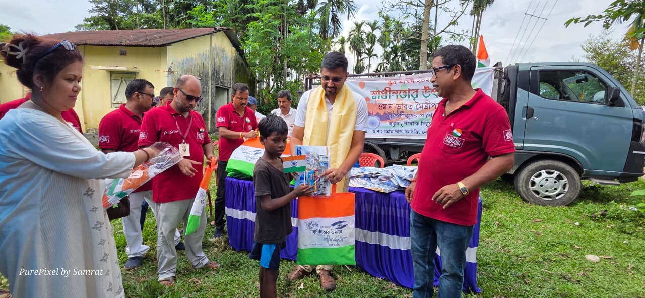 A child receiving an Independence Day gift from Abol Tabol volunteers in Totapara
