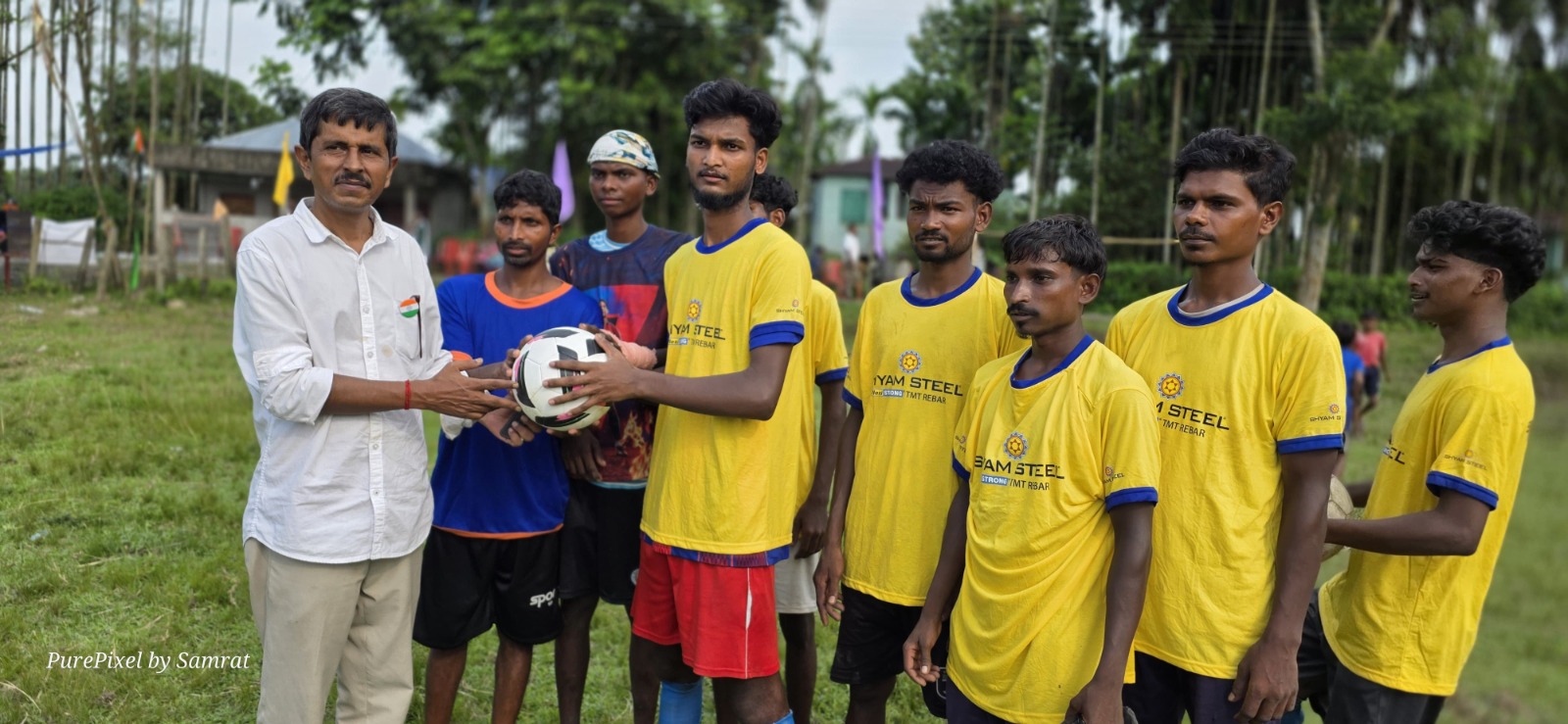 Young football players receiving a football during the community programme