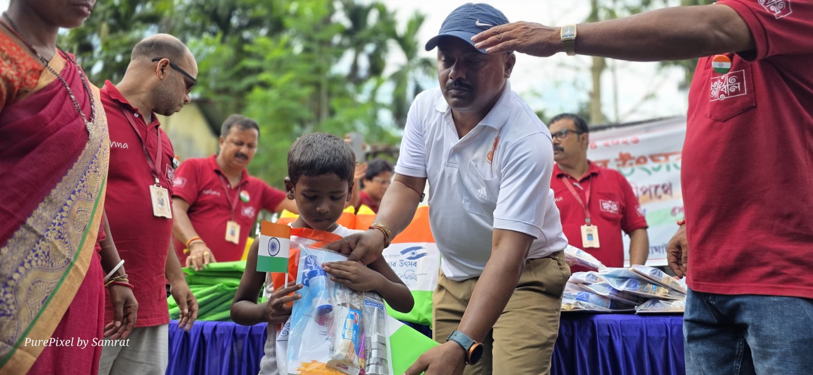 A child examining a school kit received at the Independence Day programme